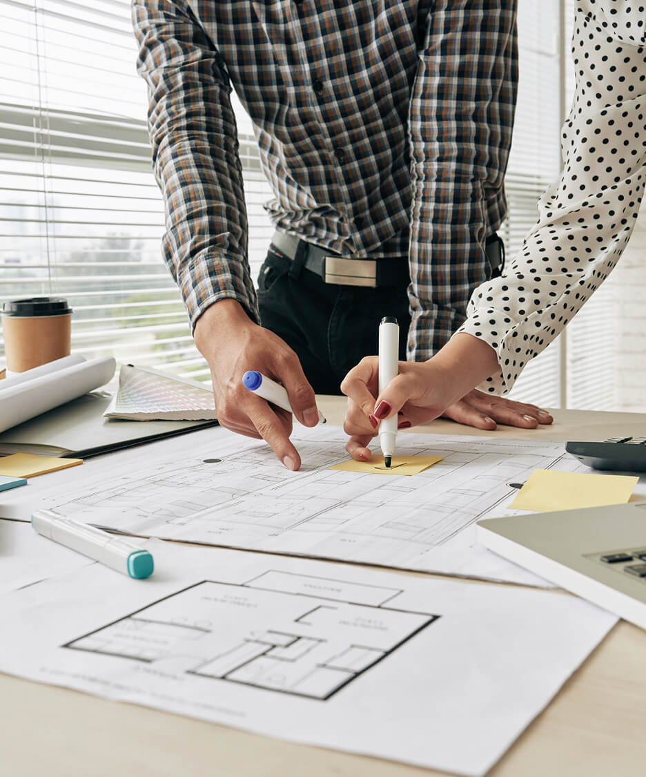 Duas pessoas fazendo marcações em uma folha